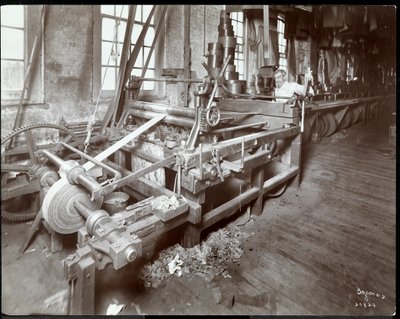 Interior view of a man working with leather at the New York Leather Belting Co., New York, 1906 by Byron Company